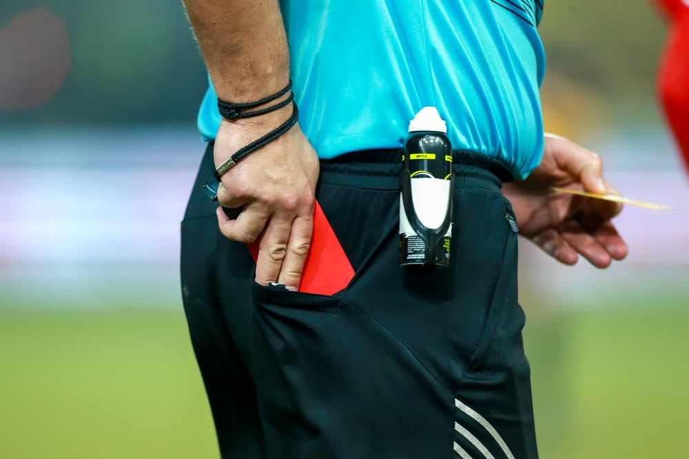 Thessaloniki, Referee drawing the red card out of his pocket.