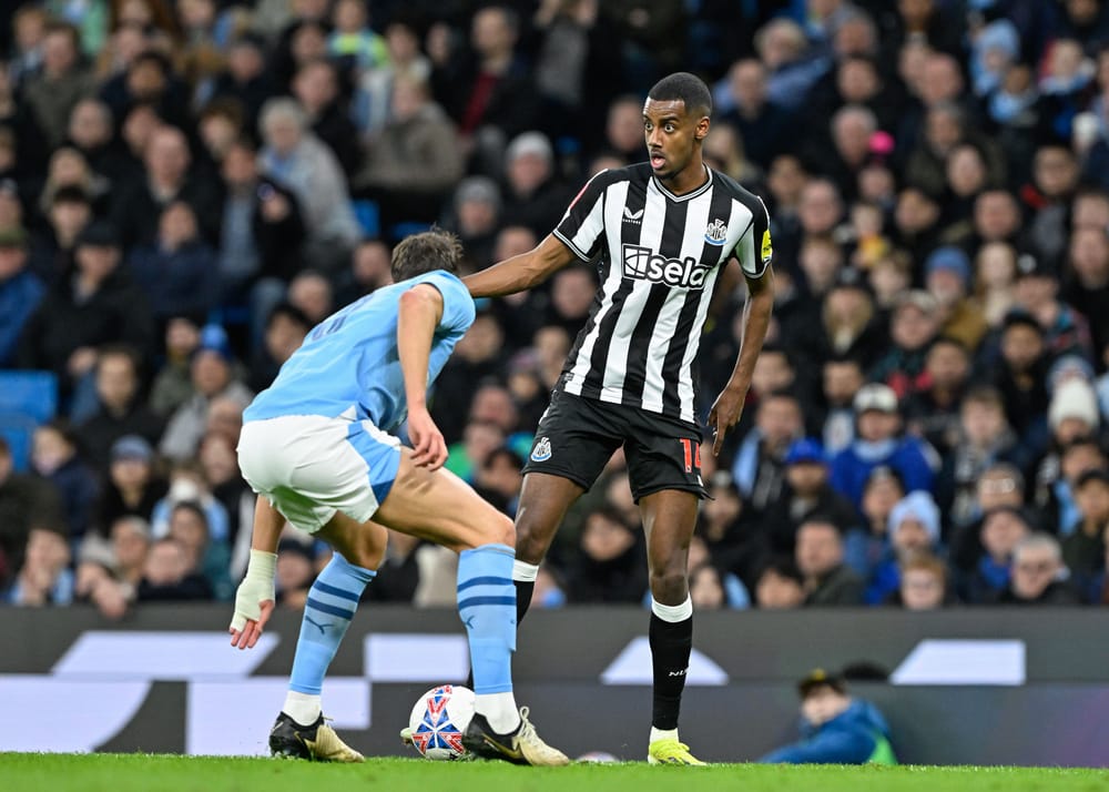 Alexander Isak of Newcastle United breaks forward with the ball.